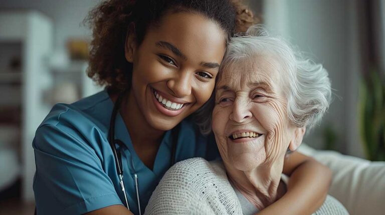 A caregiver assists an older adult with daily medication using a pill organizer at a dining table.